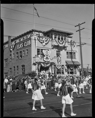 Marching band passing Elks Club building in Elks' parade, Santa Monica, 1939 or 1952