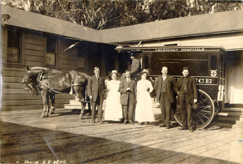 [Group of people standing in front of a horse drawn ambulance at Central Emergency Hospital]
