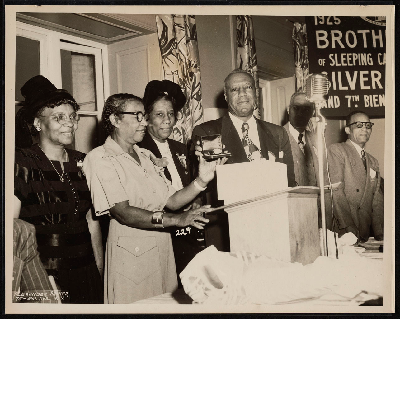 A. Philip Randolph holding watch at the Silver Jubilee and 7th Biennial Convention of the Brotherhood of Sleeping Car Porters