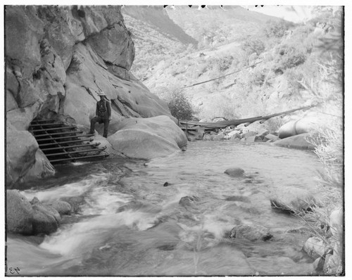 A man standing at the entrance of a tunnel intake of Kaweah #1 Hydro Plant