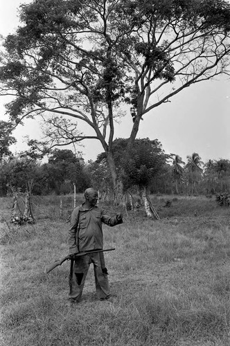 Man holding a rifle, San Basilio de Palenque, 1977