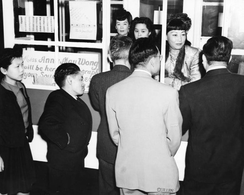 Ann May Wong signs autographs