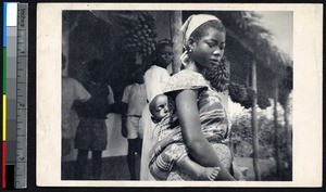 Woman carrying a sleeping child on her back, Yoko, Cameroon, ca.1920-1940