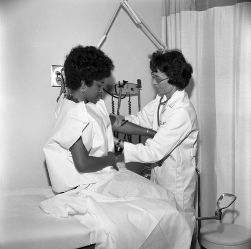 Doctor examining a woman at a family planning unit, Los Angeles, 1973