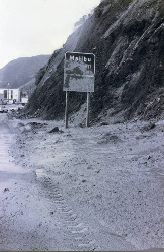 Malibu city limit sign covered in dirt after a storm, 1992
