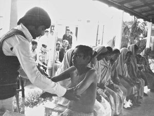 Danish Bangladesh Leprosy Mission/DBLM. Dr. Nanda Gopal Saha? examining patients at the clinic