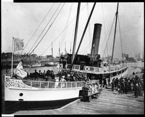 View of the Catalina passenger steamer Cabrillo loading passengers and freight alongside a Wilmington wharf, ca.1900