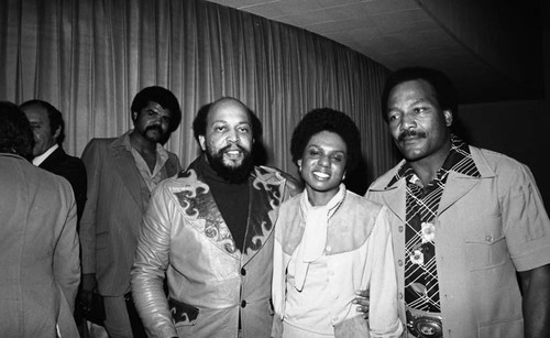 Booker Griffin, Lynette Hewette Griffin, and Jim Brown posing together, Los Angeles, 1977
