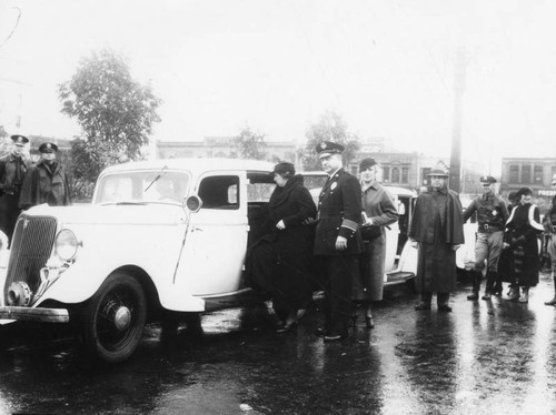 Policeman and woman entering car