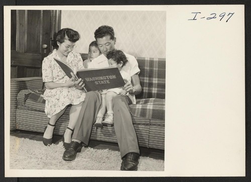 Chick Masaru Uno shows Sheila (age 6) and Naomi (age 2-1/2) a picture of their uncle, Master Sgt. Paul Uno