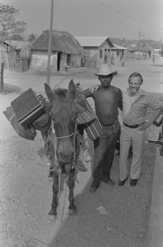 Men standing next to a loaded mule, San Basilio de Palenque, ca. 1978