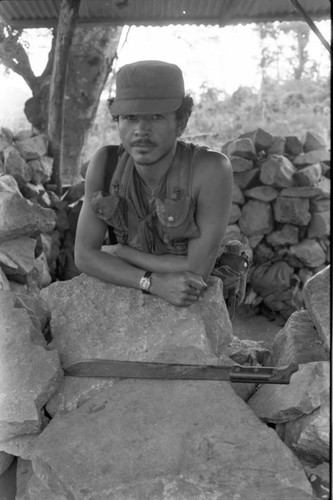 A Salvadoran Army soldier with a machete stands at an outpost , Perquín, 1983