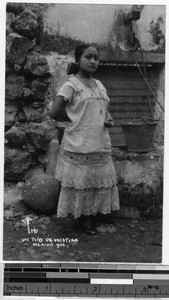 Portrait of a mestiza standing next to a well, Merida, Yucatan, Mexico, ca. 1946