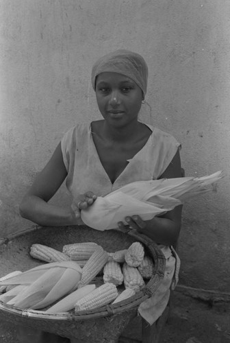 Woman removing corn husks, San Basilio de Palenque, 1976