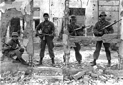 Soldiers in the ruins, El Salvador, ca. 1983