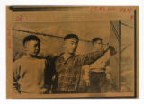 Three boys near barbed wire at Manzanar