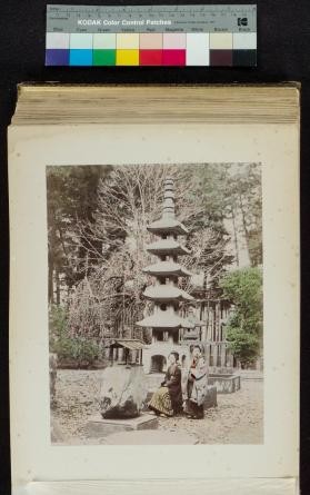 Photograph of women in Shogun Palace garden near a stone pagoda