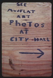 OCT78P9-11: "SEE MUDFLAT ART PHOTOS AT CITY HALL" sign