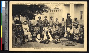 Missionary sister poses with adult women catechumens, Benin, ca. 1900-1930