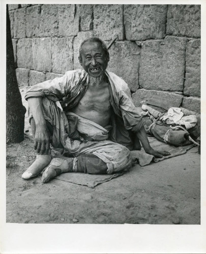 Homeless man smiling on the street