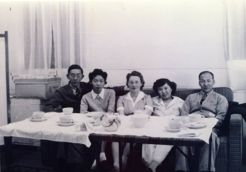 [Group photograph of two men and three women at Children's Village]