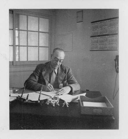 Harry Black writing at desk