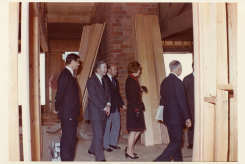 Agroup making a tour of the unfinished Brock House--L to R: Unknown man, Renfret, Chancellor Young, Mrs. Young