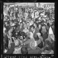 Presidential nominee Richard Nixon and his wife Pat are hemmed in by a crowd of well-wishers in 1960, Los Angeles, Calif