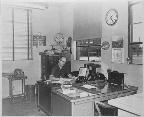 Clyde V. Fitzgerald, Assistant Sanitation Superintendant for the City of Santa Monica at his desk, March 1957