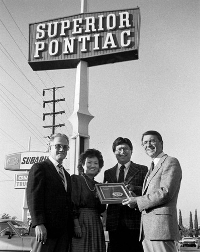 Photograph of council members in front of Superior Pontiac