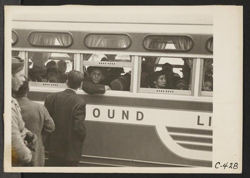 San Francisco, Calif. (2031 Bush Street)--This bus, loaded with evacuees of Japanese ancestry, is bound for Tanforan Assembly Center on the first day of evacuation of the Japanese quarter. Photographer: Lange, Dorothea San Francisco, California