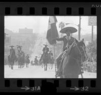 Charros riding horses in Mexican Independence Day parade in East Los Angeles, Calif., 1973