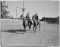 Mrs. George Diskant and Mrs. Jimmie Curtis horseback riding in Los Angeles, circa 1940