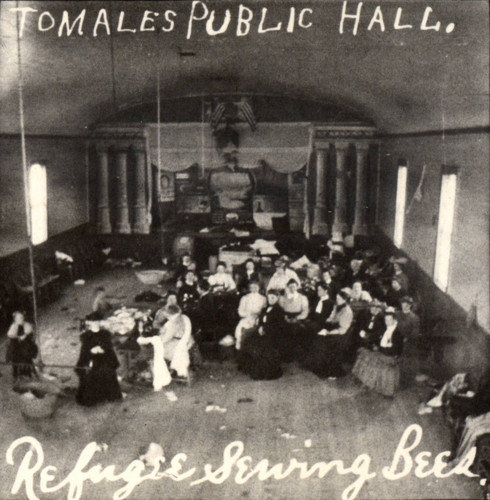 Women gather for a sewing bee in Tomales' Public Hall, to aid the refugee victims of the earthquake of April 18, 1906, Marin County, California[photograph]