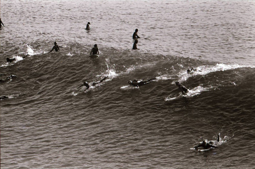 Surfers viewed from Huntington Beach pier