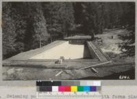 Swimming pool at Whitaker's Forest with forms placed by Civilian Conservation Corps crew for pouring sidewalk. June. 1937. Metcalf