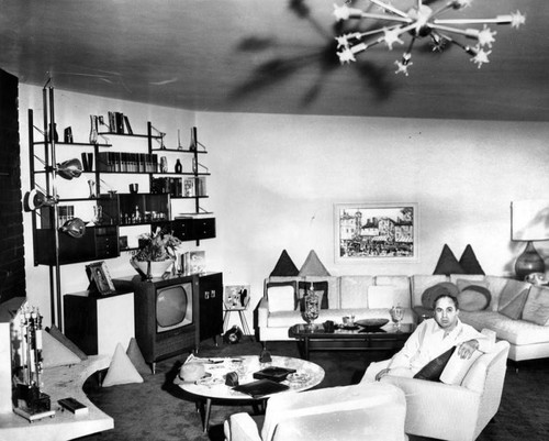 Mickey Cohen in living room of plush apartment