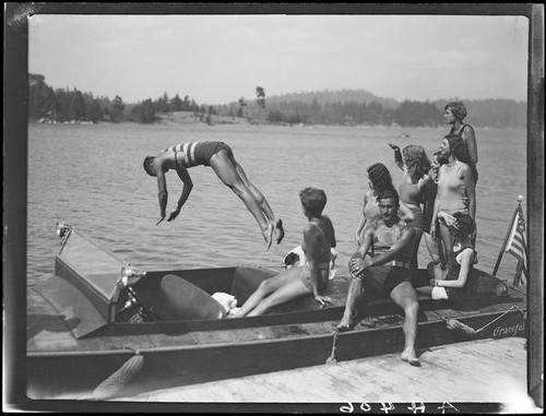Young man diving from motorboat "Graceful," Lake Arrowhead, 1929