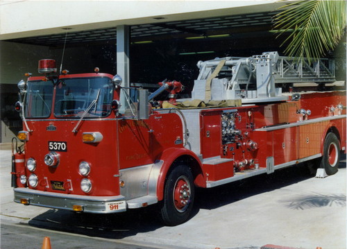1969 Crown fire truck with 100’ aerial ladder parked in front of fire station at 1001 Sixth Street