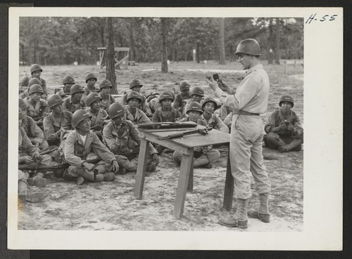 Lieutenant Watt instructs a class in the mechanism of the Ml rifle. The 442nd combat team at Camp Shelby is