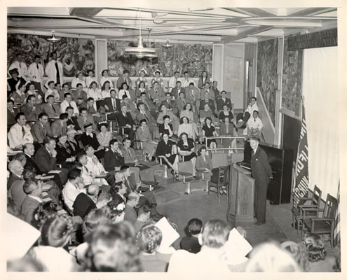 [Dr. Stafford Warren, M. A. M. D., speaking before an audience in Leland Hall at U. C. Medical Center]