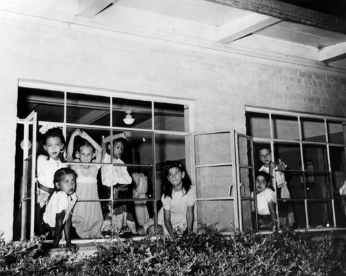 Children posing in the windows, Ramona Gardens