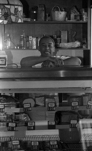 Mr. Arsonond posing behind the counter, Los Angeles, 1986