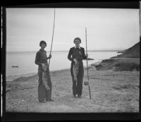 Mildred Fletcher and Louise Whitney stand on the beach with fish they caught in the Gulf of California, Mexico, 1935