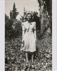 Mary McGregor standing in front of a large tree, Santa Rosa, California, about 1941