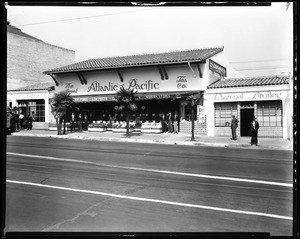 Exterior view of an A&P Market (The Great Atlantic and Pacific Tea Company), showing men dressed in tuxedoes