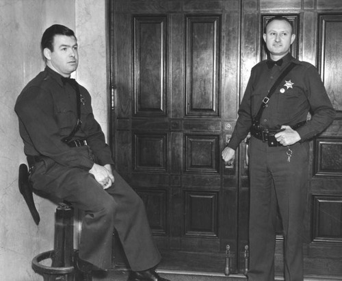 Dick Dailey and Fred Keithley guarding courtroom