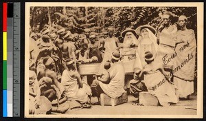 Group watching the bathing of a baby, Rwanda, ca.1920-1940