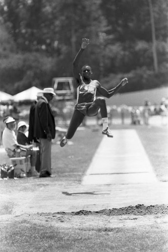 Carl Lewis completing a long jump, Los Angeles, 1982