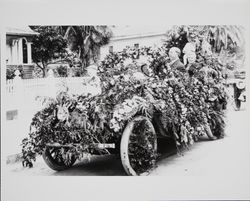 Car decorated with garlands and flowers--doll sitting on the hood